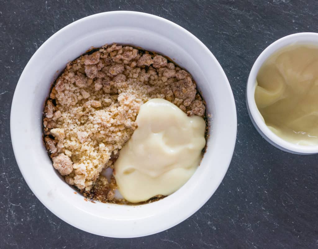 Gluten free, vegan, Bramley apple and quince crumble with vegan custard. Ready to eat.