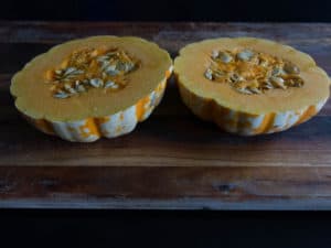 Squash/ pumpkin cut around the equator. Ready to be de-seeded, seasoned and roasted.