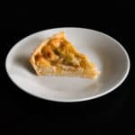 Slice of gluten free, vegan Pear Frangipane Tart. Delicious autumn dessert.